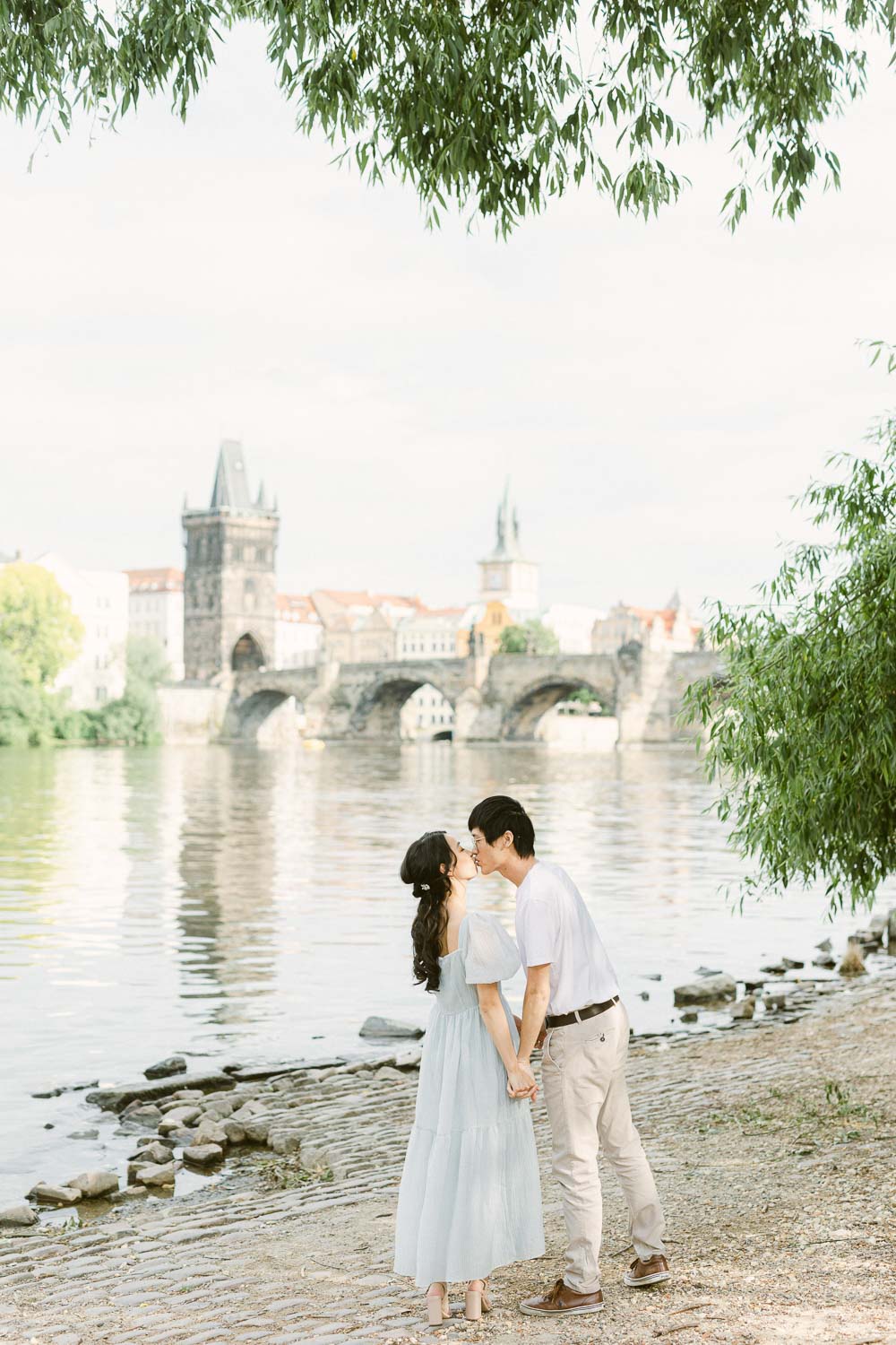 couple in front of a charles bridge
